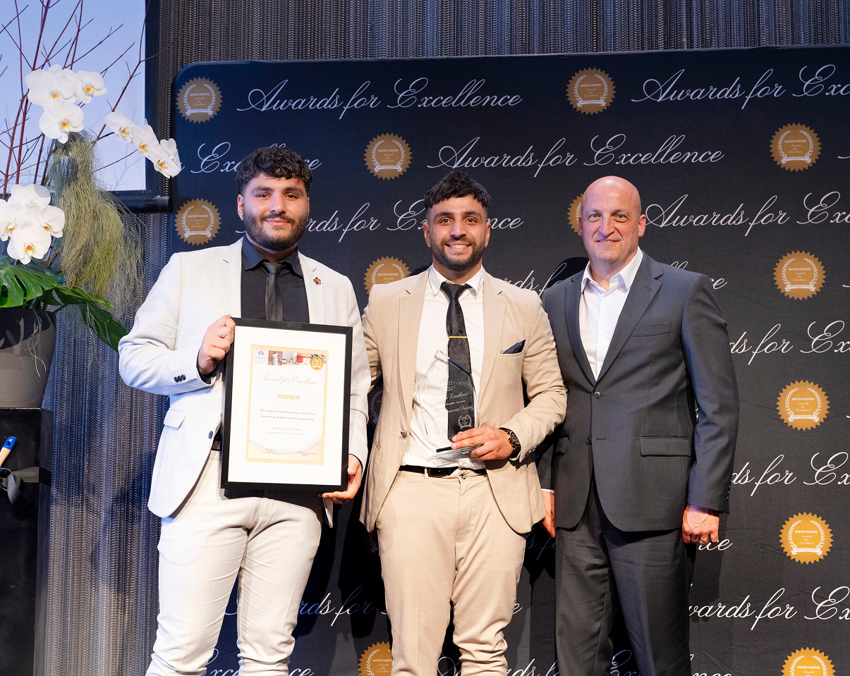 ACP team accepting a Master Painters award on stage